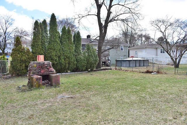 view of yard with fence and a fenced in pool