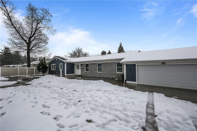 snow covered house with a garage