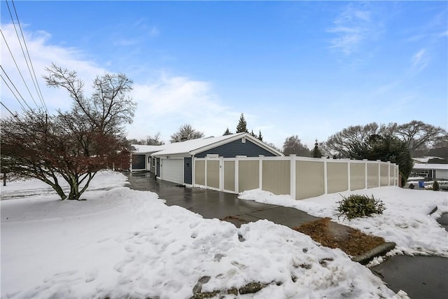 exterior space featuring a garage and fence