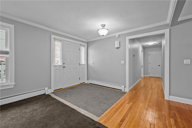 entrance foyer featuring ornamental molding, a baseboard radiator, and hardwood / wood-style flooring