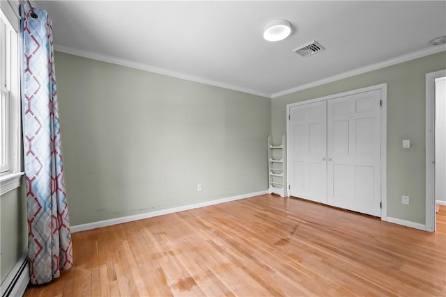 unfurnished bedroom featuring baseboards, a baseboard radiator, visible vents, and crown molding