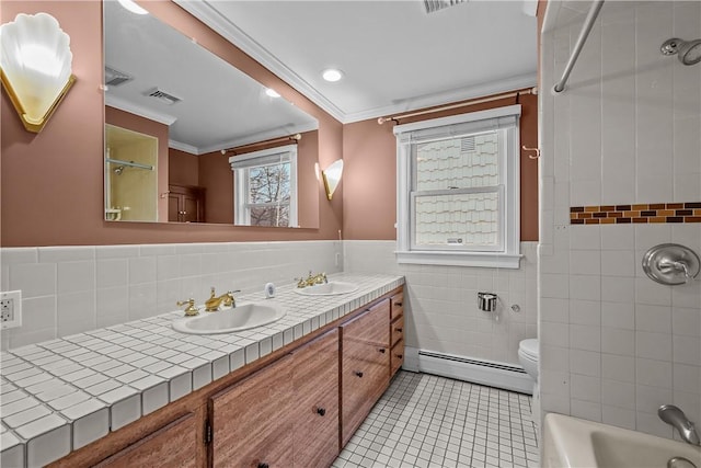 full bathroom with visible vents, a sink, tile patterned flooring, a baseboard heating unit, and tile walls