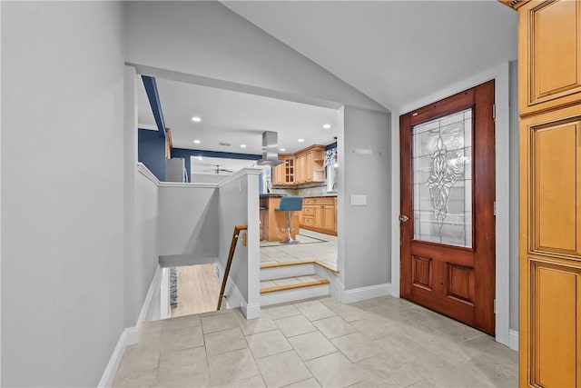 entrance foyer with vaulted ceiling, light tile patterned floors, baseboards, and recessed lighting