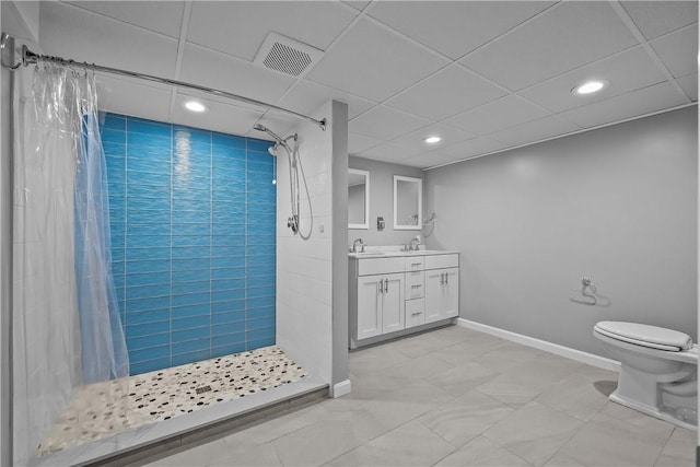 bathroom with double vanity, visible vents, toilet, a shower stall, and baseboards