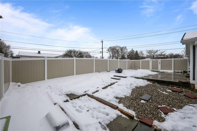 snowy yard featuring fence