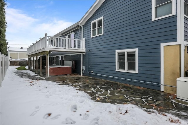 snow covered property featuring a wooden deck