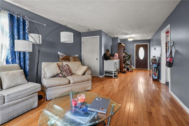 living area with hardwood / wood-style flooring and baseboards