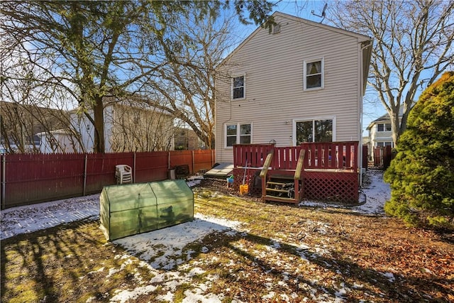 rear view of property featuring a fenced backyard and a deck