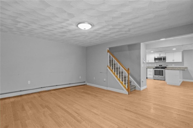 unfurnished living room with a textured ceiling, a baseboard radiator, baseboards, stairs, and light wood finished floors