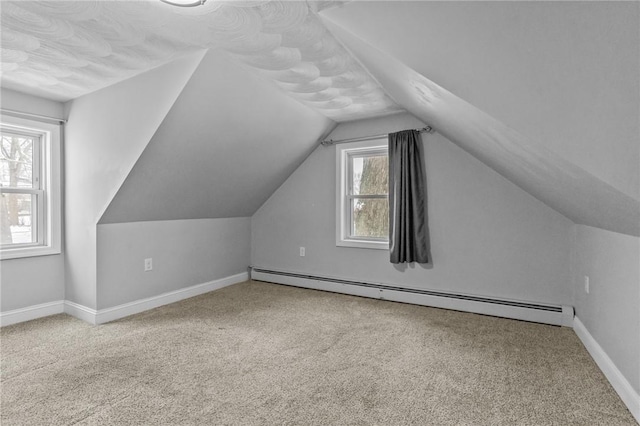 bonus room featuring a baseboard radiator, baseboards, vaulted ceiling, and carpet flooring