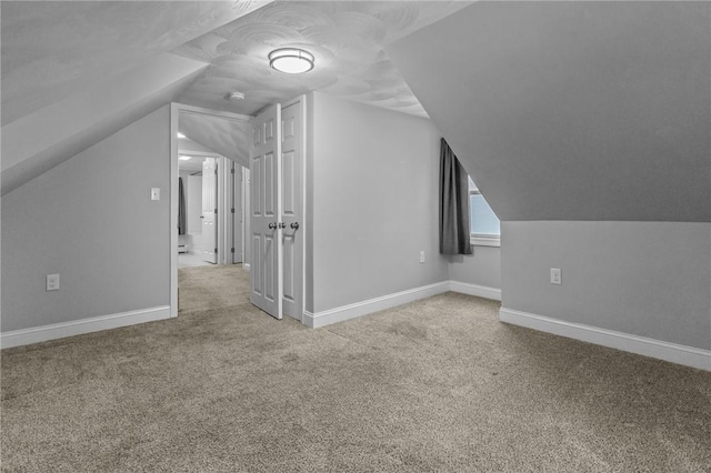 bonus room with carpet, vaulted ceiling, and baseboards