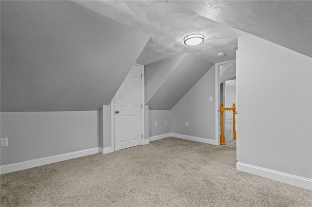 bonus room featuring carpet, lofted ceiling, and baseboards