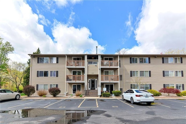 view of property featuring uncovered parking