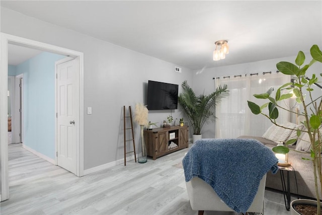 interior space with baseboards and wood finished floors