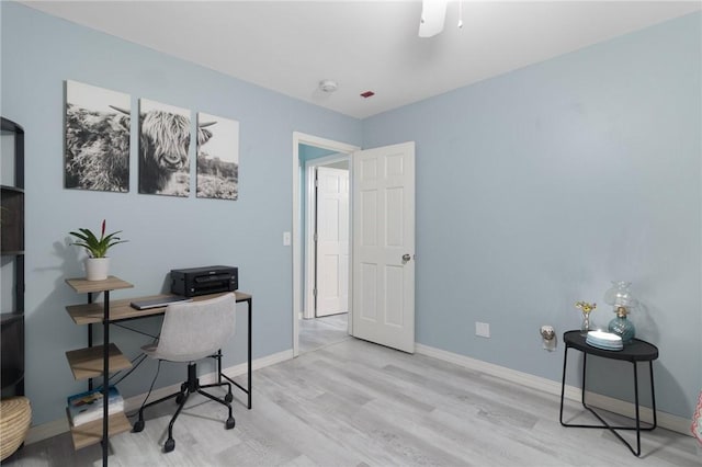 home office featuring baseboards and wood finished floors