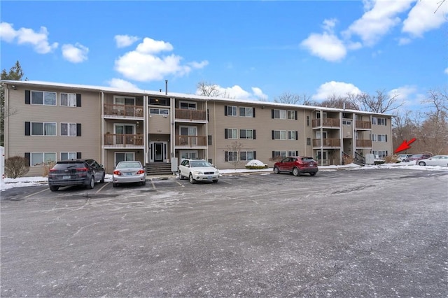 view of building exterior with uncovered parking