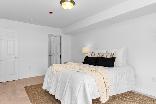 bedroom featuring wood finished floors and baseboards