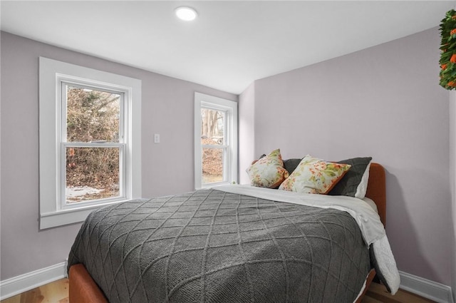 bedroom featuring baseboards and wood finished floors