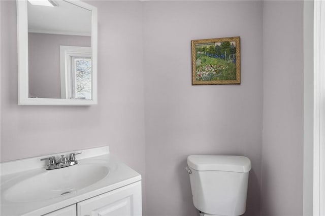 half bath featuring toilet and vanity