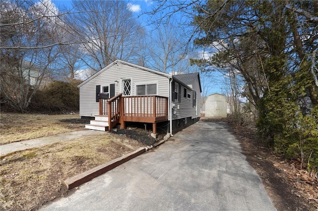 view of front facade with driveway and a deck