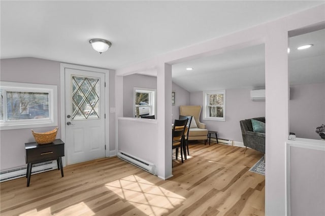 foyer featuring light wood-style floors, a baseboard radiator, and baseboard heating