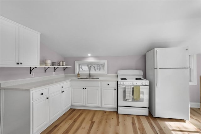 kitchen featuring light countertops, white appliances, a sink, and white cabinets