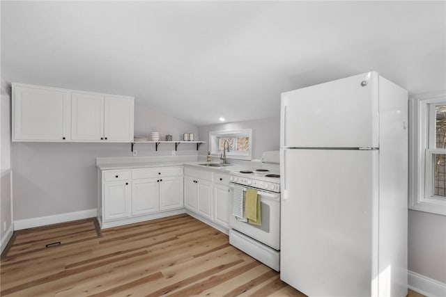 kitchen featuring white appliances, light countertops, light wood-style floors, white cabinetry, and a sink