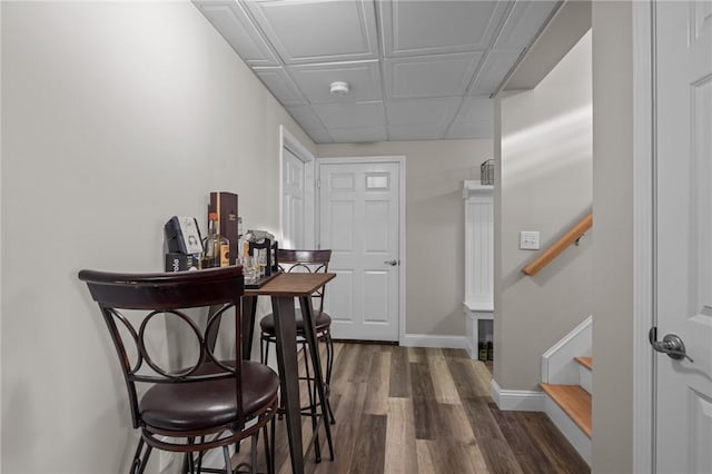 interior space with baseboards, stairway, and dark wood-type flooring