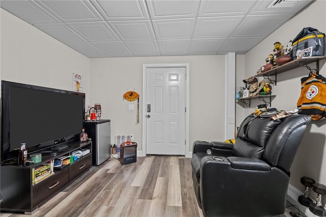 living room featuring light wood finished floors and baseboards