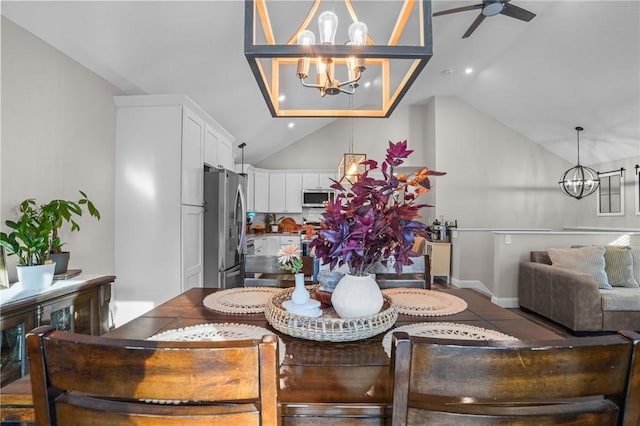 tiled dining room featuring lofted ceiling and ceiling fan with notable chandelier