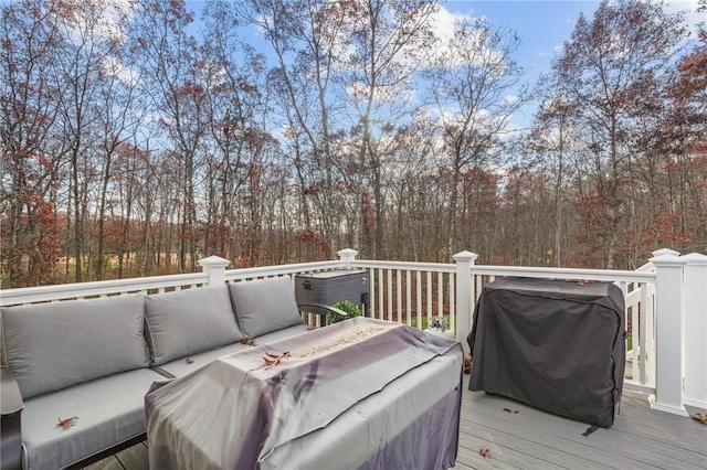 wooden terrace featuring grilling area and an outdoor hangout area