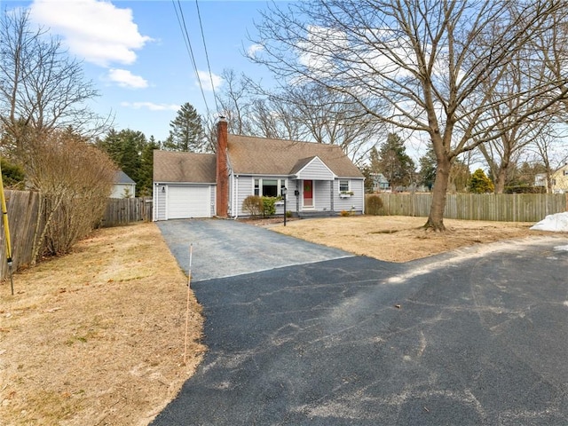 4 Country Ct, East Greenwich, RI 02818 - view of front facade featuring a garage, aphalt driveway, a chimney, and fence