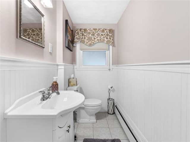 bathroom featuring toilet, a wainscoted wall, a baseboard radiator, tile patterned floors, and vanity