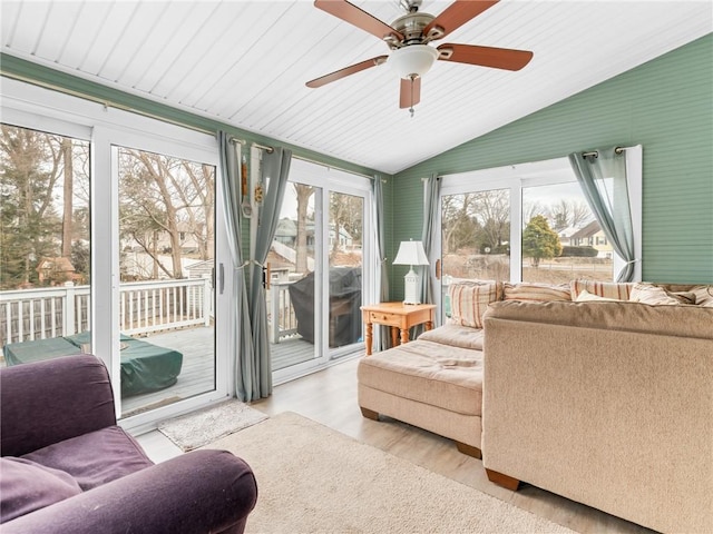 sunroom / solarium with a ceiling fan and vaulted ceiling