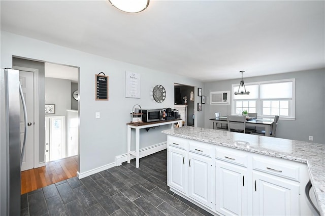 kitchen featuring dark wood-style flooring, decorative light fixtures, stainless steel appliances, baseboard heating, and white cabinets