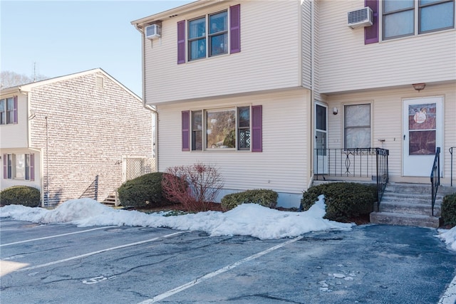 view of front of home featuring a wall mounted air conditioner