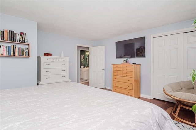 bedroom featuring baseboards, a closet, and wood finished floors