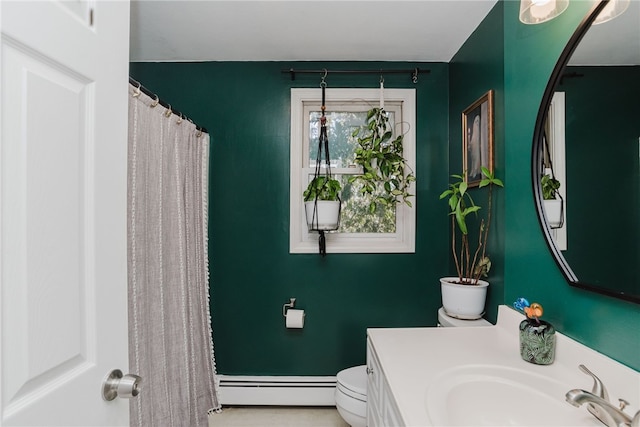 bathroom with toilet, a sink, and baseboard heating