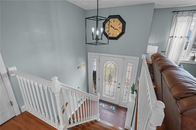 foyer with an inviting chandelier and wood finished floors