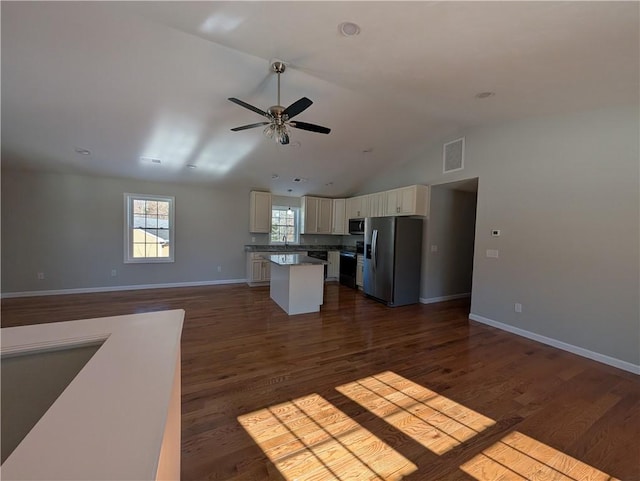 kitchen with stainless steel appliances, visible vents, open floor plan, a center island, and dark wood-style floors