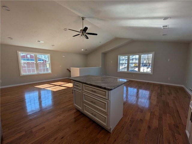 kitchen with baseboards, dark wood finished floors, a kitchen island, open floor plan, and vaulted ceiling