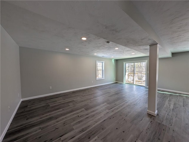 basement featuring recessed lighting, baseboards, and wood finished floors