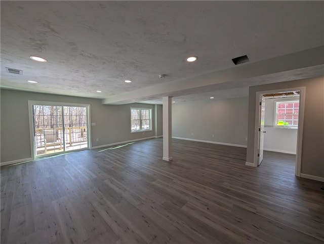 interior space with dark wood-type flooring, visible vents, and plenty of natural light