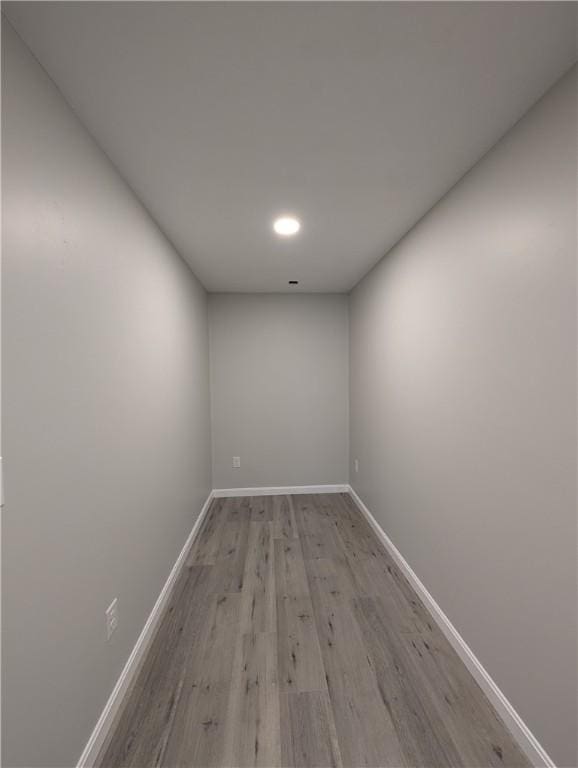 spare room featuring light wood-style floors and baseboards