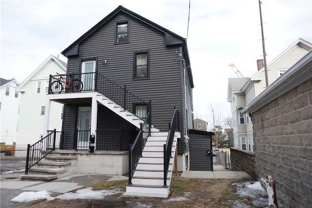 view of front of home featuring a balcony and stairway