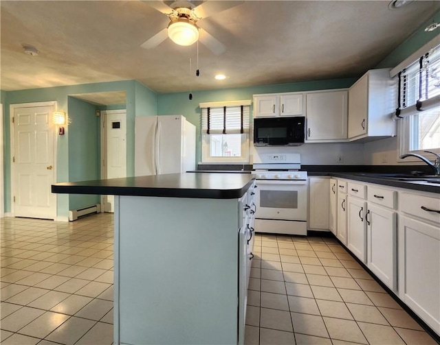 kitchen with dark countertops, white appliances, white cabinetry, and light tile patterned floors