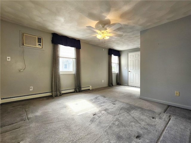 unfurnished room featuring a wall unit AC, ceiling fan, baseboards, and carpet flooring