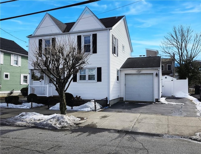 view of front facade with aphalt driveway and an attached garage