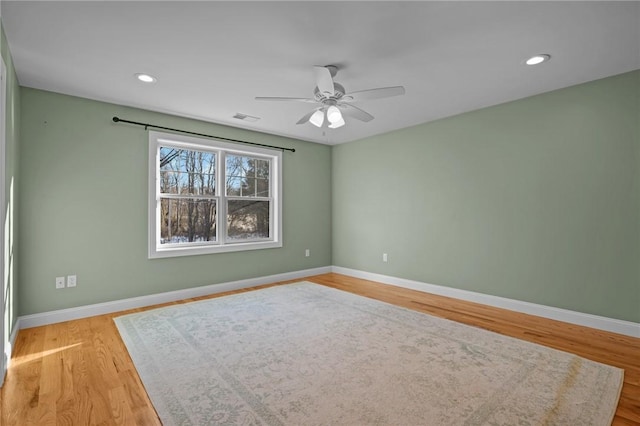 spare room featuring visible vents, baseboards, a ceiling fan, light wood-style flooring, and recessed lighting