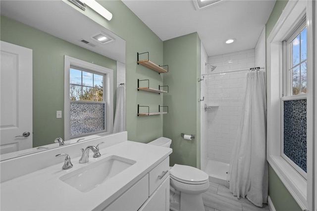 full bath with visible vents, a shower stall, toilet, and vanity